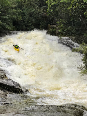 Rudnei Ribeiro behind the camera capturing Chris Baer on the first big slide of Little Hell, huge slide jungle, kayaking, whitewater
