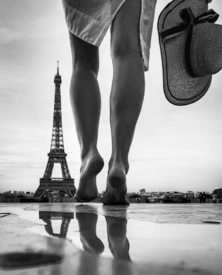 Barefoot girl walking toward the Eiffel Tower