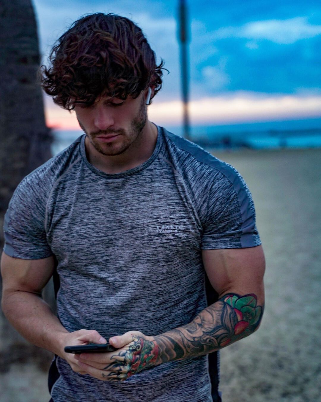 handsome-strong-straight-bodybuilder-owen-harrison-texting-tattoo-arm-curly-brown-hair-hunk
