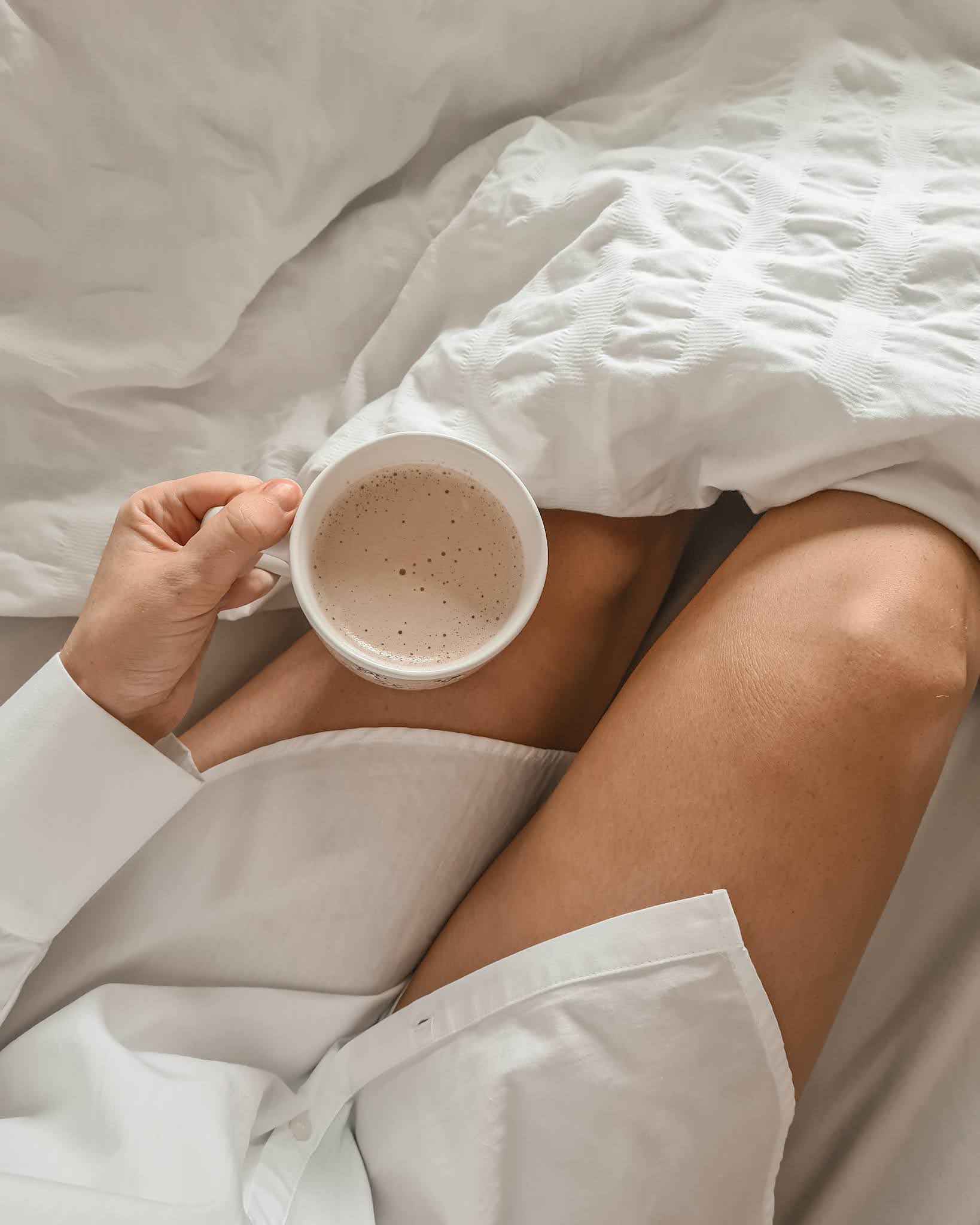 A girl in bed with a cup of tea