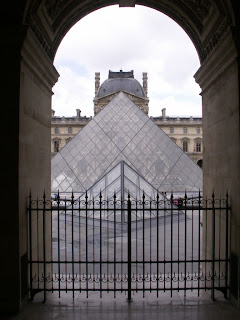 two of the glass pyramids at the louvre in paris