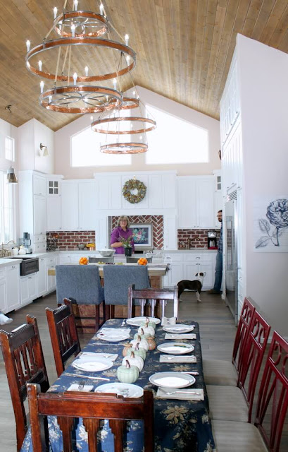 Kitchen with white kitchen and wood ceiling