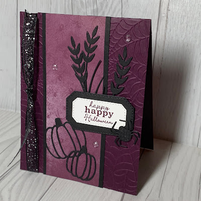 Halloween Card with two pumpkins, spiders, and spider webs with a glittery black ribbon