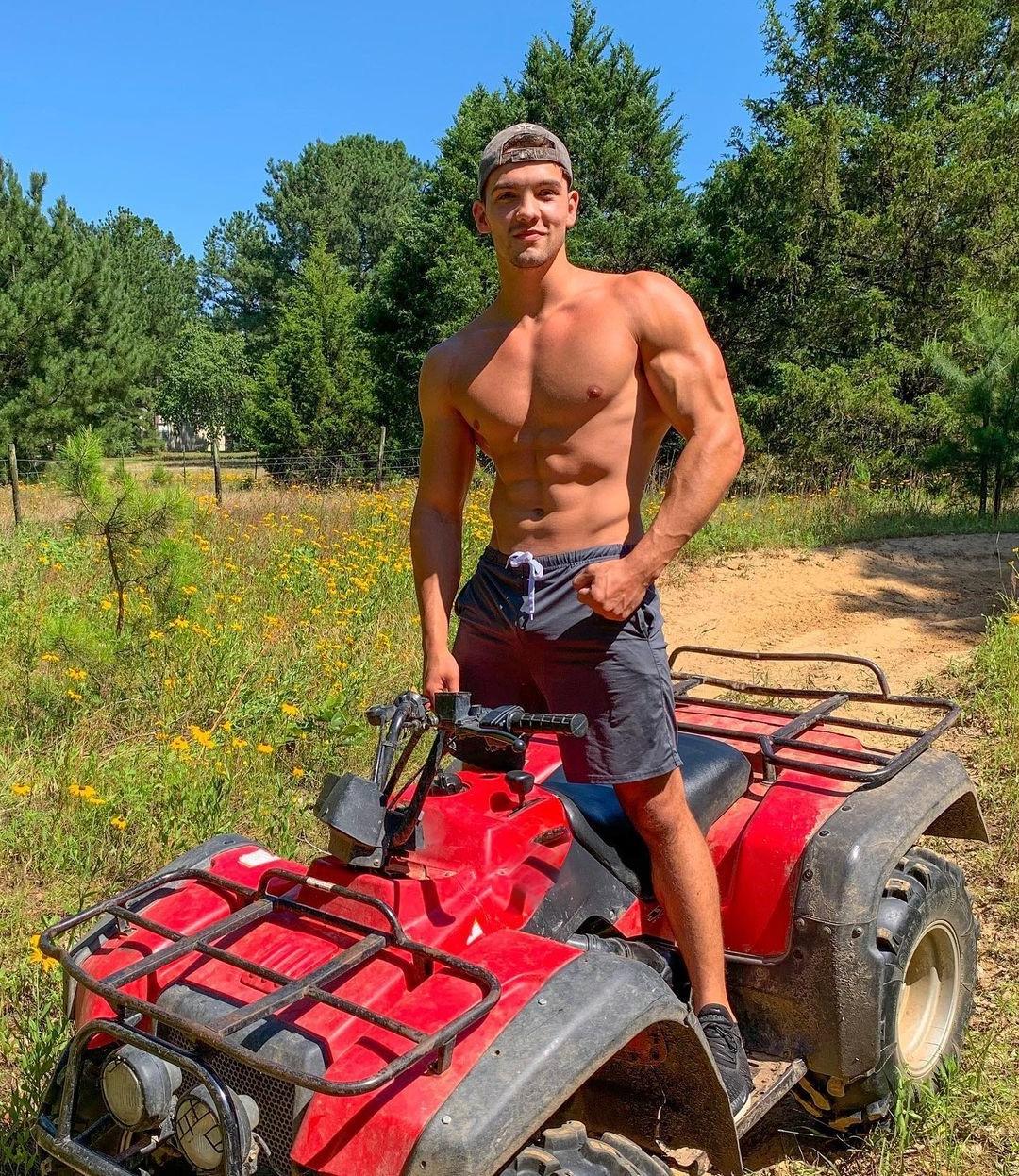 cute-fit-shirtless-baseball-cap-dude-riding-motorcycle-outdoors-adventure