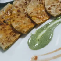 Serving paneer paratha with green chutney and tomato sauce for paneer paratha recipe