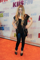 Avril Lavigne posing for cameras on the red carpet