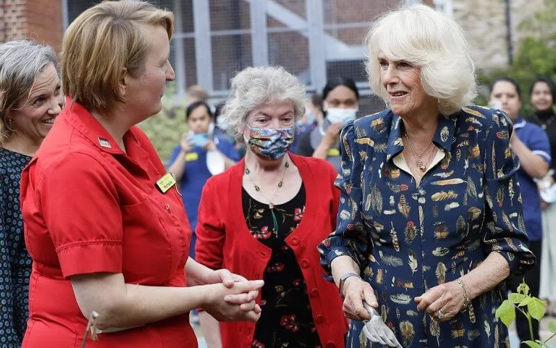 The Duchess of Cornwall wore a navy blue shirt dress with feather print detail