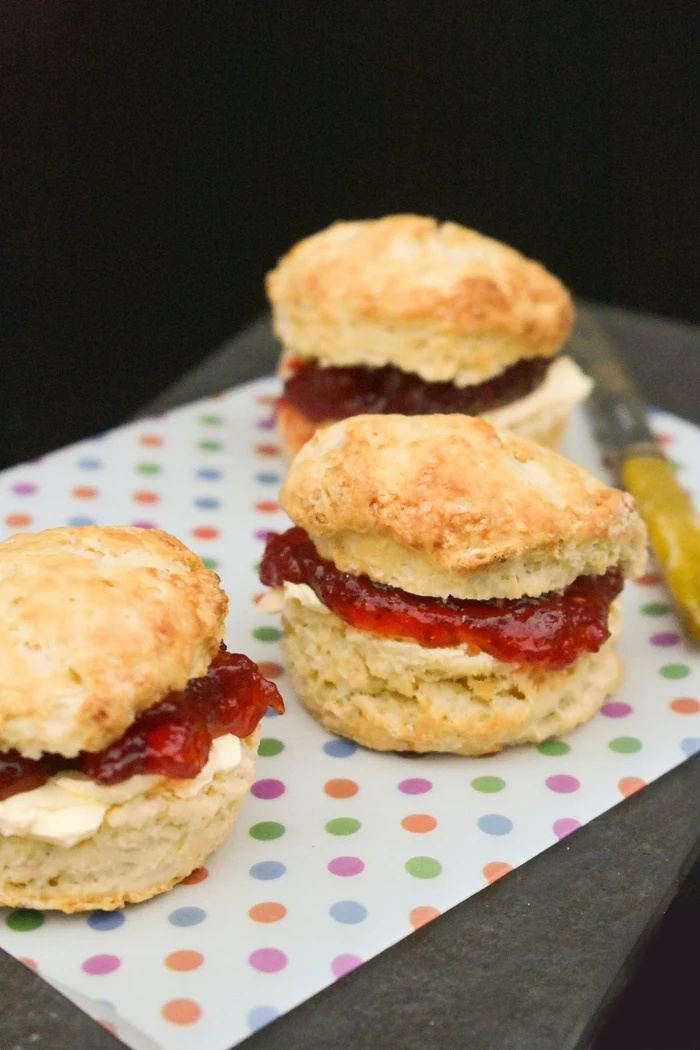 Close up of Light and fluffy Scottish scones baked to a vegan recipe and filled with dairy-free spread and jam