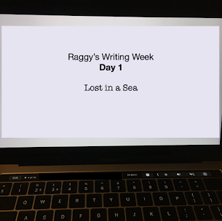 Laptop screen with text 'Raggy's Writing Week Day 1: Lost in a Sea'