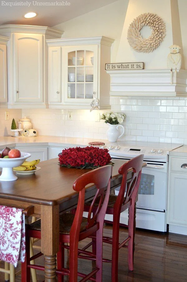 Red and Cream Farmhouse Kitchen with wooden wreath on hood
