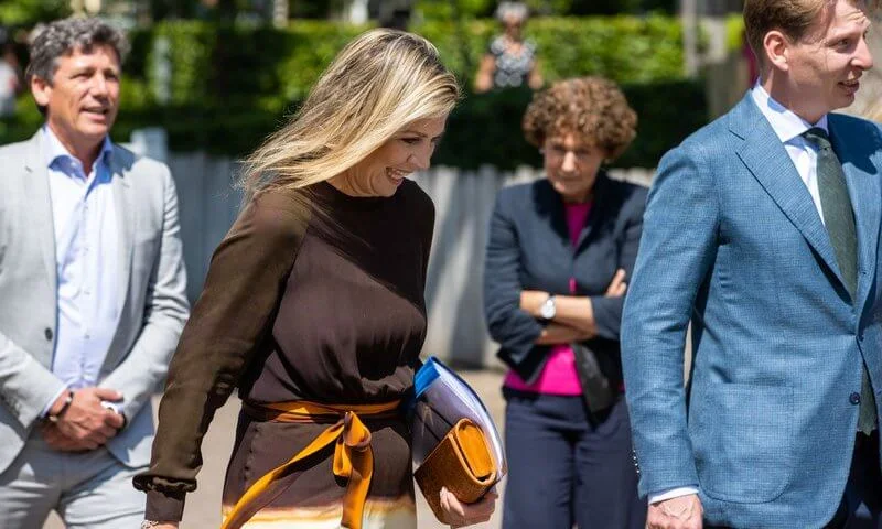 Queen Maxima wore a silk twill dress from Jan Taminiau, and she wore rose flower coral earrings from Van Cleef and Arpels