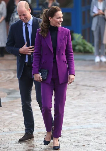 Kate Middleton wore a purple suit by Emilia Wickstead. Emmy London Josie pumps and Jaeger quilted bag