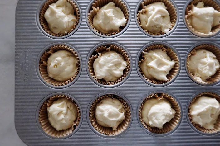cupcake batter in muffin cups in tin