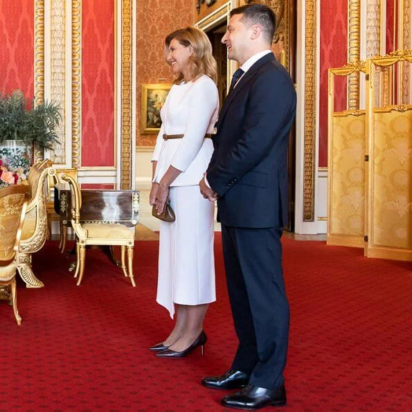 Kate Middleton wore a blue v-neck belted bespoke dress from Emilia Wickstead, and her praline Gianvito Rossi pumps. First Lady Olena Zelenska