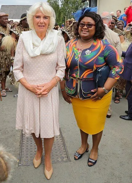 Prince Charles and Duchess of Cornwall met with King Goodwill and Queen Pumi of the Zulus. Burberry trench coat