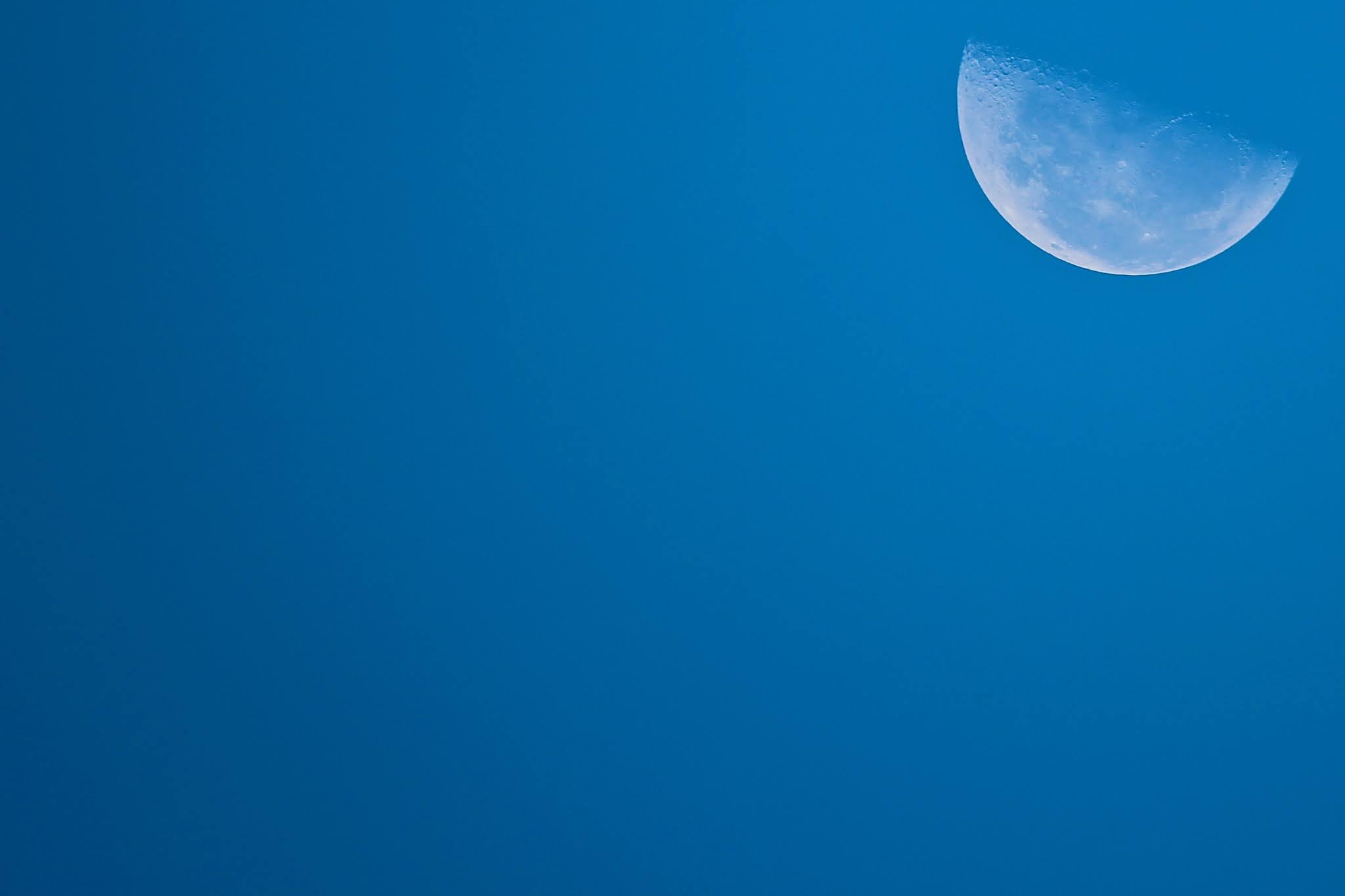 Moon In The Clear Blue Sky Background