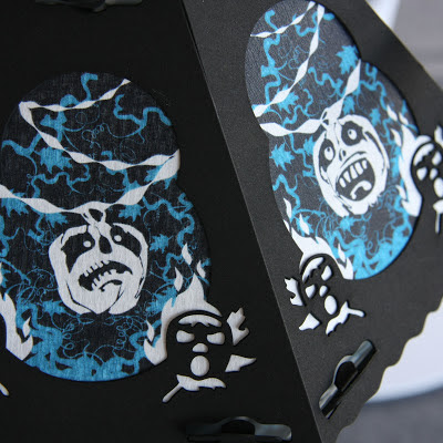 Close-up photo of 2 panels of a vintage styled Halloween lantern by Bindlegrim from 2012