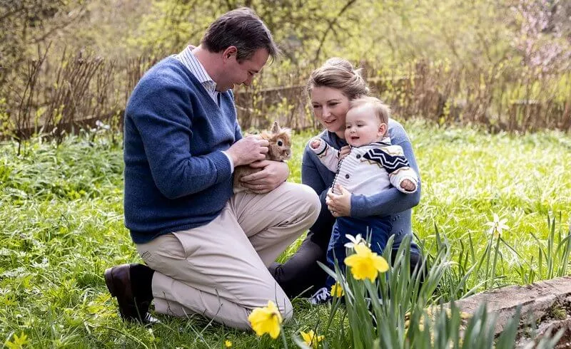 Blue high neck wool sweater. feather earrings. Princess Stephanie wore a blue white geo coral silk dress from Boden