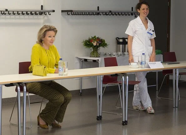 Queen Mathilde wore Natan yellow silk blouse and print pants. Natan clutch bag. Dries Van Noten print trousers