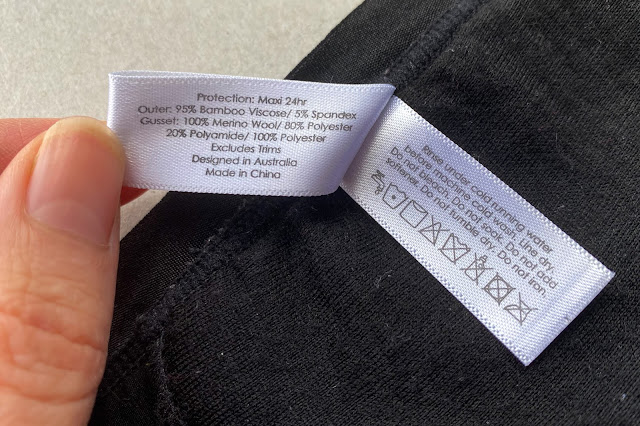 close up of the care label and fabric information on Modibodi Maxi-24 hour black period pants