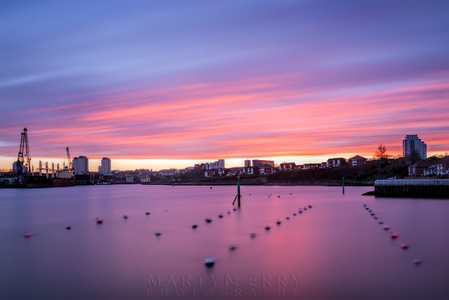 Sunset clouds move over the harbour and city of Sunderland Long exposure image of sunset colours above the Sunderland skyline