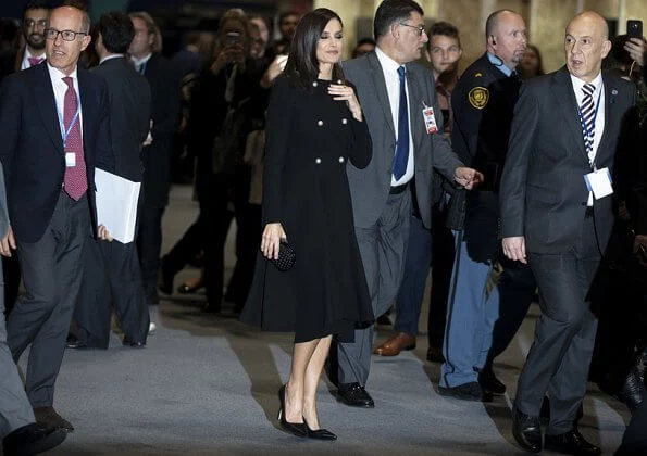 Queen Letizia carried Bottega Veneta black knot ntrecciato satin clutch and wore Prada toe pumps at COP25 event