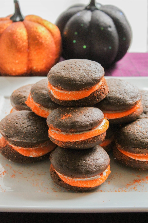 These light and fluffy little chocolate cakes are sandwiched together by a creamy marshmallow buttercream. Adding orange sprinkles to the exposed frosting turns these Halloween Whoopie Pies into a fun and festive treat!
