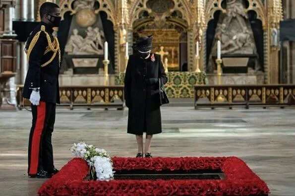 Queen Elizabeth wore a black mask and Jardine diamond star brooch.  National Service of Remembrance at The Cenotaph