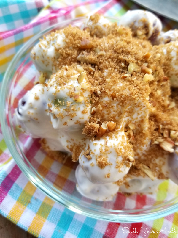 Grape Salad | A sweet salad recipe of green and red grapes dressed in a sweet silky cream cheese and sour cream mixture sprinkled with a brown sugar pecan topping.