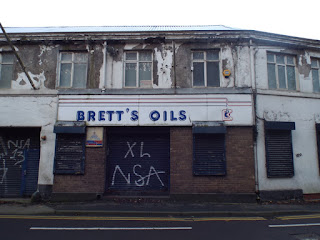 A boarded up entrance to Brett Oils on Pipewellgate