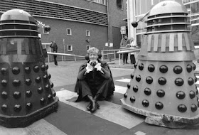 1972:  Dr Who, played by Jon Pertwee (1919 - 1996) sits in the car park of the BBC guarded by two Daleks, robotic creatures from the popular tv series.  (Photo by Express/Express/Getty Images)
