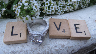 the word love in scrabble pieces with ring for the O