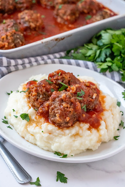 meatballs on a plate with mashed potatoes.