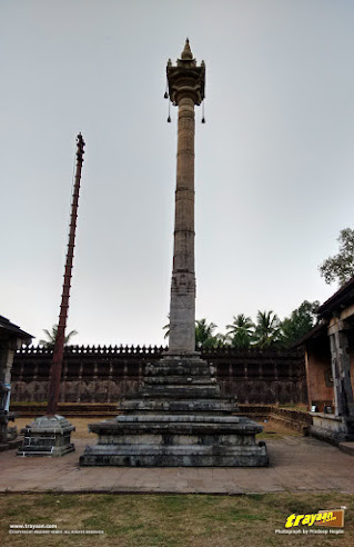 50 feet tall pillar or Manasthambha before the Thousand Pillared Jain Temple in Moodabidri, near Mangalore, Karnataka, India - called as Tribhuvana Tilaka Chudamani basadi or Chandranatha basadi, also known as Saavira Kambada Basadi in Dakshina Kannada district, near Mangalore, Mangaluru, Karnataka, India