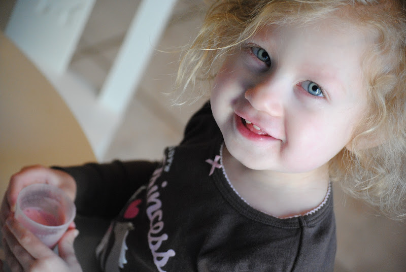 Little girl drinking a fruit smoothie