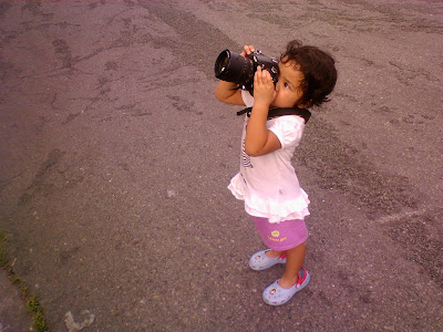 Kecil taking photo with big camera