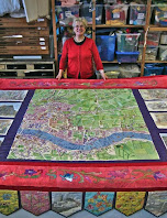 Diana England stands in front of her millennium tapestry