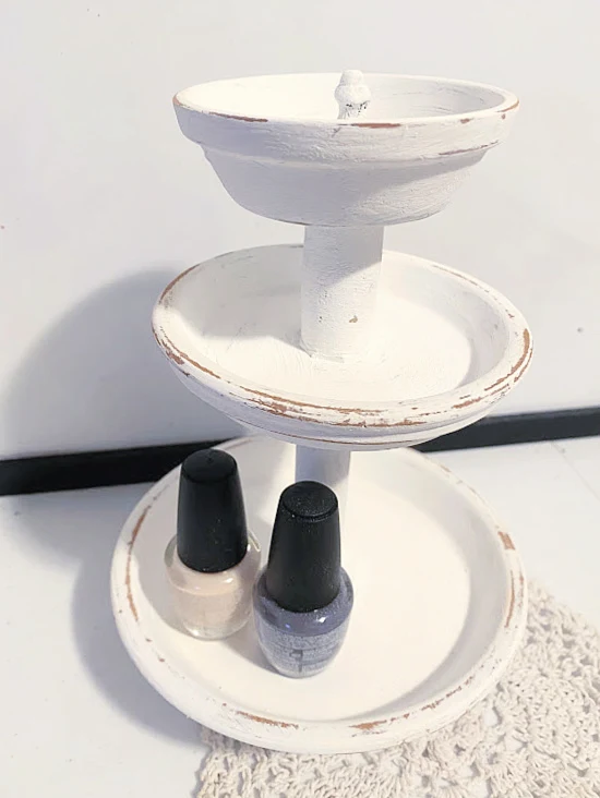 distressed pedestal dish with nailpolishes