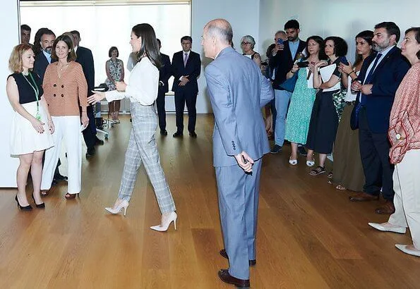 Hugo Boss prince of wales checked trousers, and Boss white silk blouse, and Magrit pumps, diamon earrings