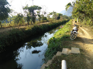 Riding dangerously along the narrow road to finally reach Pha Thao caves.