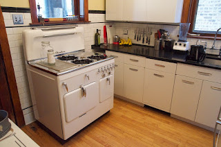 White Chambers stove Model C highback in retro kitchen with steel cabinets, Chicago, Illinois