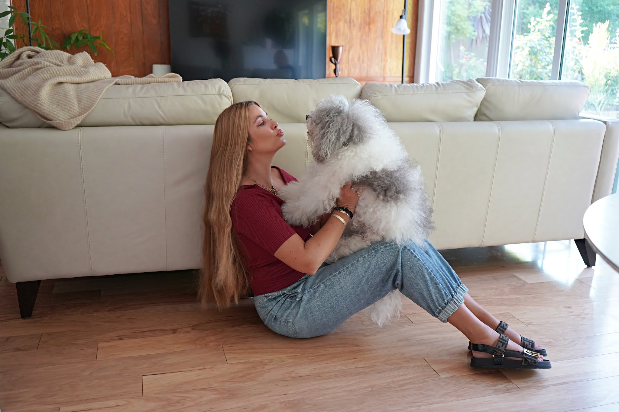 woman playing with her dog and showing products from Beauty from Nordstrom