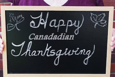 Happy Canada Thanksgiving written on black board.