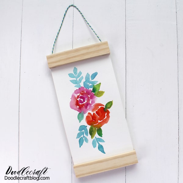 Make a hanging scroll from recycled materials. This elegant and simple painted floral scroll makes a great gift or gorgeous home decor. This great scroll-like technique works for any type of art--including the kids doodles.