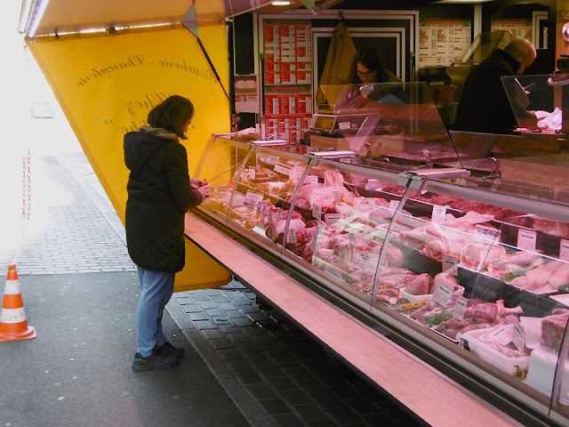 Shopping at a butchers stall in a regional market, Indre et Loire, France. Photo by Loire Valley Time Travel.