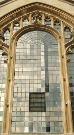 Photograph of sky reflected in a leaded window
