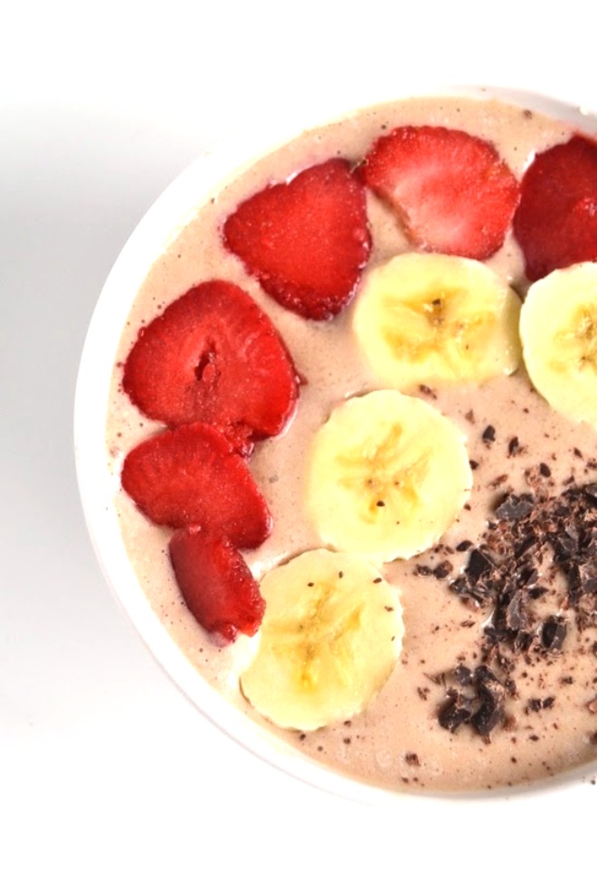This Banana Split Smoothie Bowl tastes like your favorite dessert but is much healthier! It includes the traditional flavors including banana, strawberries and chocolate. www.nutritionistreviews.com