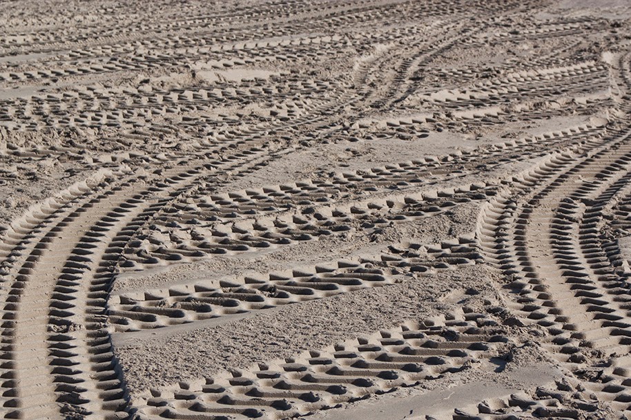 pattern of tire prints in sand