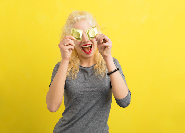 Woman holding condoms