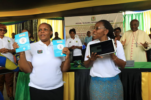 Naibu Katibu Mkuu Wizara ya Elimu, Sayansi na Teknolojia Dkt. Ave Maria Semakafu akionesha kishkwambi chenye kamusi huku Mkurugenzi Mtendaji wa Taasisi ya Elimu Tanzania Dkt. Magret Komba akionesha Mwongozo wa Utekelezaji wa Mtaala wa Elimu ya Sekondari kwa wanafunzi viziwi mara baada ya kuzinduliwa katika kilele cha maadhimisho ya viziwi yaliuofanyika Mkoani Tabora